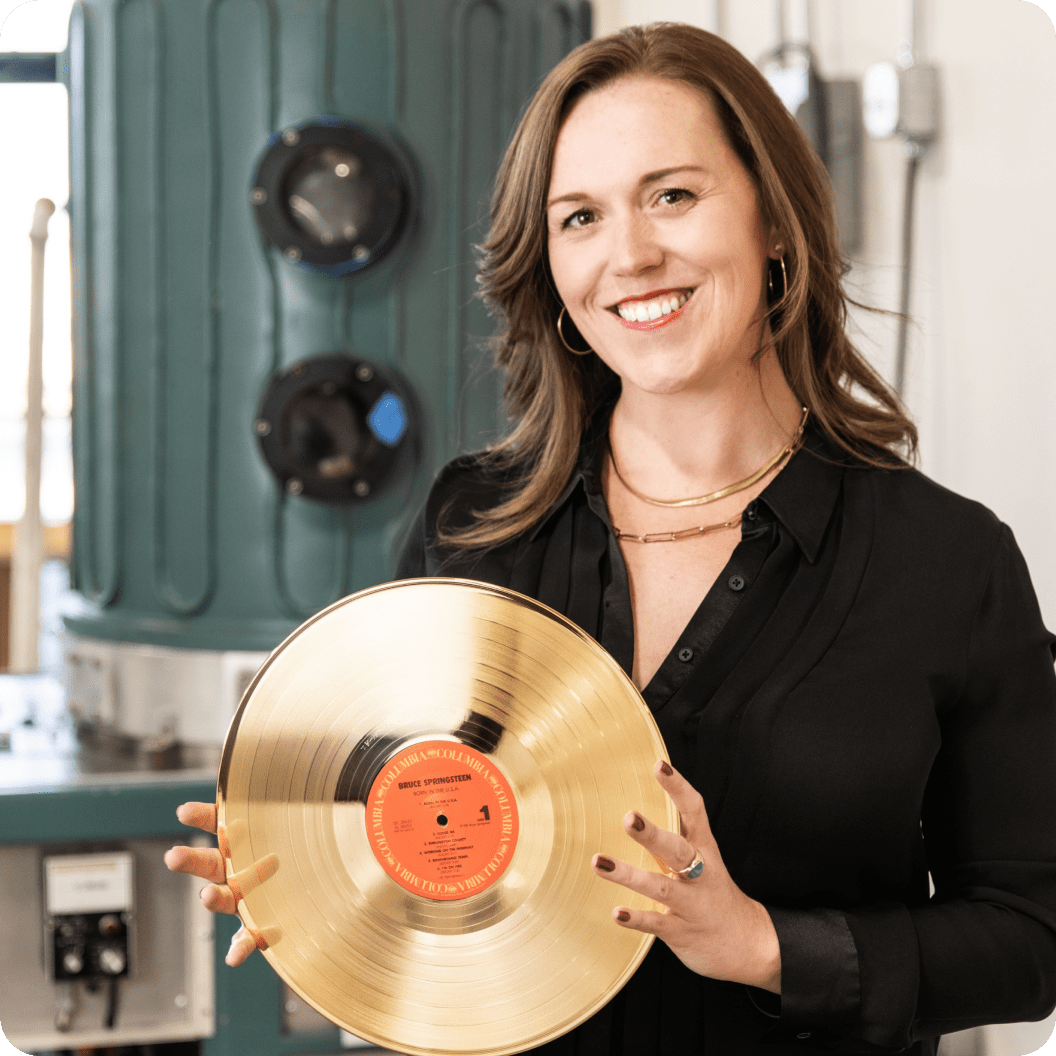 Caren Kelleher of Gold Rush Vinyl holding a golden record